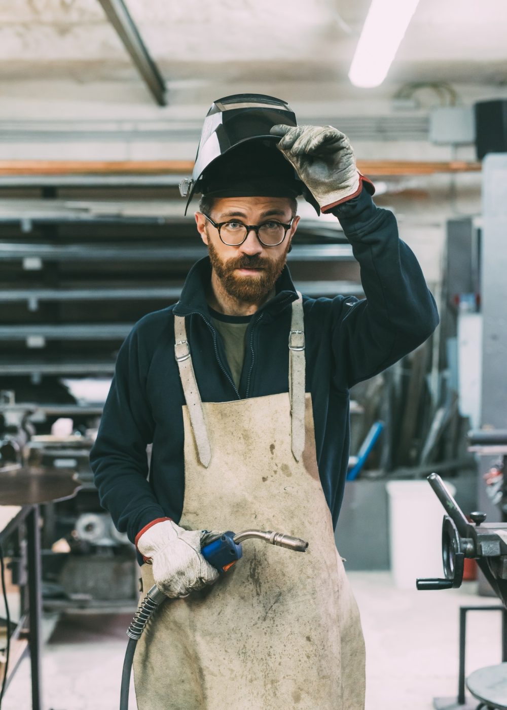 portrait-of-metalworker-holding-welding-torch-in-forge-workshop.jpg portrait-of-metalworker-holding-welding-torch-in-forge-workshop.jpg